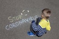 Boy draws on the asphalt.