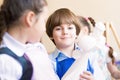 Boy draws in class with other children Royalty Free Stock Photo