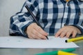 The boy draws felt-tip pens on paper. Drawing. Little boy. Children`s drawing. Developmental activities Royalty Free Stock Photo