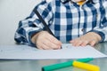 The boy draws felt-tip pens on paper. Drawing. Little boy. Children`s drawing. Developmental activities Royalty Free Stock Photo