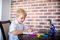 Boy draws with markers