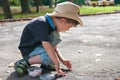 Boy draws on the road with chalk Royalty Free Stock Photo