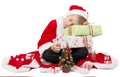 Boy dressed as Santa sleeping on Christmas gift Royalty Free Stock Photo