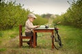 A boy dressed in a retro style resting on the meadow