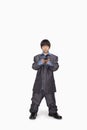 Boy dressed up as businessman checking cell phone, studio shot Royalty Free Stock Photo