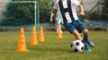 Boy Dribble a Soccer Ball Between Cones. Football Training Class For Kids