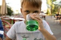 Boy drinking green lemonade