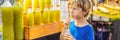 Boy drinking sugar cane juice on the Asian market BANNER, LONG FORMAT Royalty Free Stock Photo