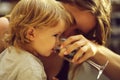 Boy drinking water with mother