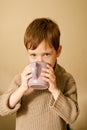 Boy drinks cocoa. Warm autumn photography.