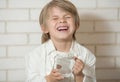 The boy drinks water from a glass cup Royalty Free Stock Photo