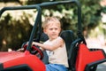 Boy drive electric mini park in park Royalty Free Stock Photo