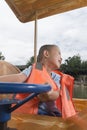 Boy driving boat Royalty Free Stock Photo