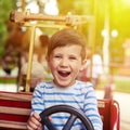 Boy driving a car on merry-go-round Royalty Free Stock Photo