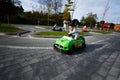 Boy driving racing kart car at amusement park Royalty Free Stock Photo