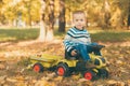 Boy driving a toy truck in park Royalty Free Stock Photo