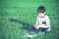 Boy with drone sittting on the grass.