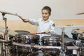 Boy drumming. boy in a white shirt plays the drums. A boy in a white shirt is drumming