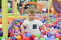 A boy in a dry paddling pool in playing centre with plastic balls Royalty Free Stock Photo