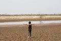 Boy in dryland looking at drought landscape. Concept for climate change from global worming.