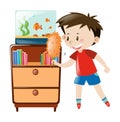 Boy dusting shelf and fishtank