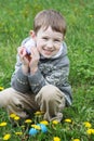 Boy with eastre egg among spring garden Royalty Free Stock Photo