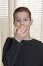 Boy eating apple front view
