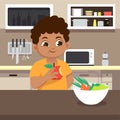 Boy eating apple at kitchen with happy face Royalty Free Stock Photo