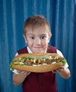 Boy eating big sandwiches Royalty Free Stock Photo