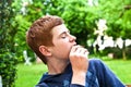 Boy eating a bread in the garden Royalty Free Stock Photo