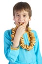 The boy eating a bread ring over white Royalty Free Stock Photo