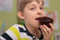 Boy eating caloric muffin Royalty Free Stock Photo
