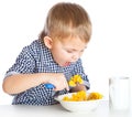 A boy is eating cereal from a bowl Royalty Free Stock Photo