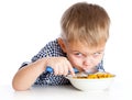 A boy is eating cereal from a bowl Royalty Free Stock Photo