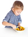 A boy is eating cereal from a bowl Royalty Free Stock Photo