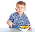 A boy is eating cereal from a bowl Royalty Free Stock Photo