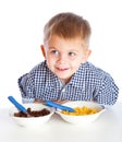 A boy is eating cereal from a bowl Royalty Free Stock Photo