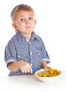 A boy is eating cereal from a bowl Royalty Free Stock Photo