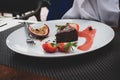 Boy eating chocolate brownie and berries. Royalty Free Stock Photo