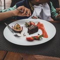 Boy eating chocolate brownie and berries. Royalty Free Stock Photo