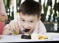 Boy eating chocolate lava cake happily Royalty Free Stock Photo