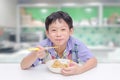 Boy eating noodle by chob stick