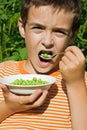 Boy eating peas Royalty Free Stock Photo