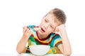 boy eating porridge, portrait of a child isolated on white Royalty Free Stock Photo