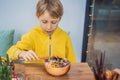 Boy eating Raw Organic Poke Bowl with Rice and Veggies close-up on the table. Top view from above horizontal Royalty Free Stock Photo