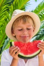 Boy eating red ripe watermelon. Summertime, holidays and vacations concept Royalty Free Stock Photo