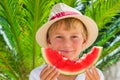 Boy eating red ripe watermelon. Summertime, holidays and vacations concept Royalty Free Stock Photo