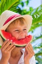 Boy eating red ripe watermelon. Summertime, holidays and vacations concept Royalty Free Stock Photo