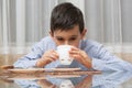 Boy eating soup at the kitchen table Royalty Free Stock Photo