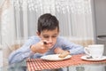 Boy eating soup at the kitchen table Royalty Free Stock Photo